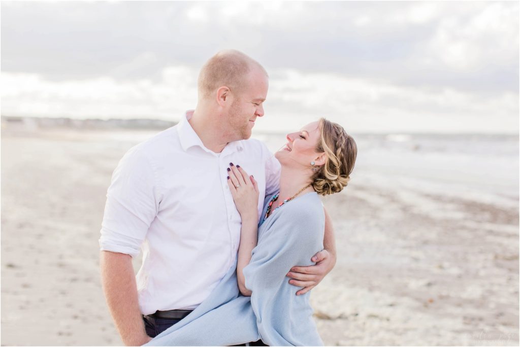 couple looking at each other on white horse beach