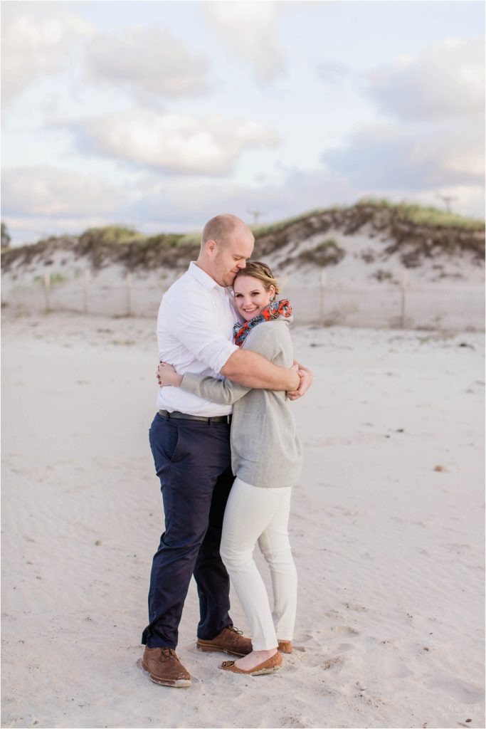 man kissing woman on forehead on beach