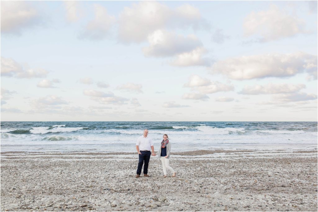 man and woman standing in front of ocean