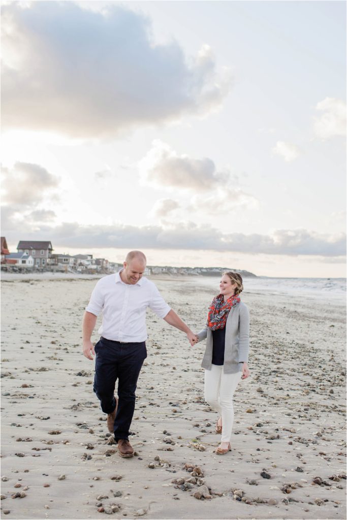 man and woman walking together on beach
