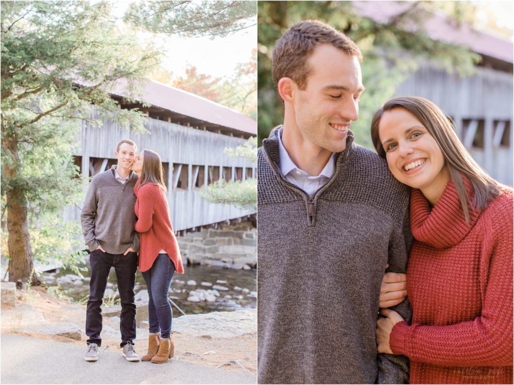 couple standing in front of covered bridge at sunset