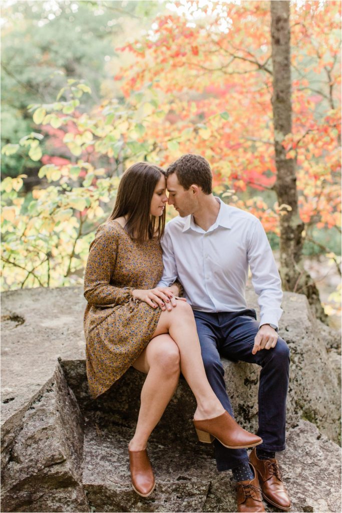 couple sitting together on rock