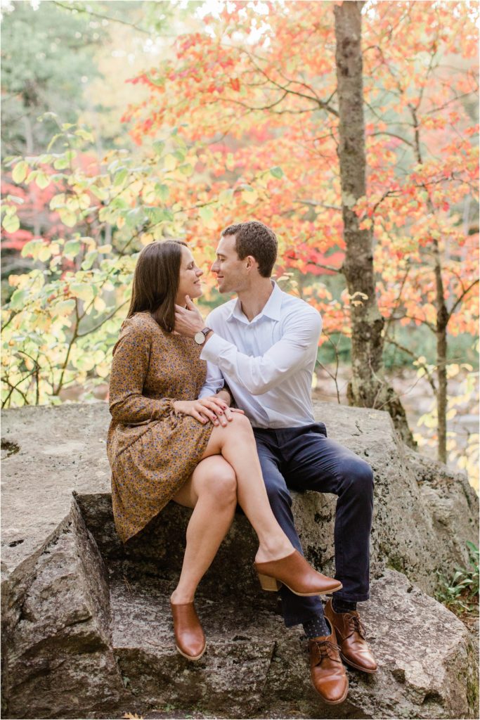 couple sitting together on rock