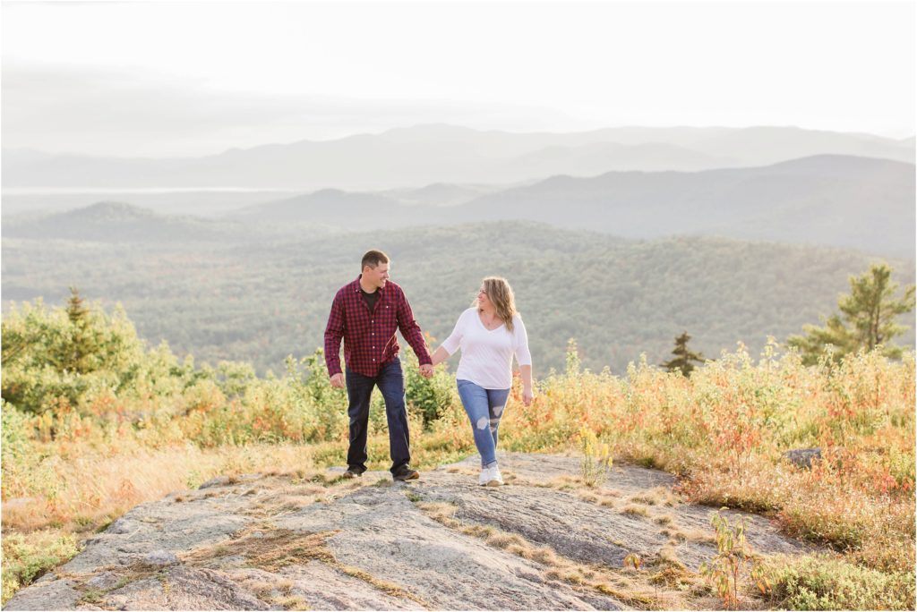 man and woman walking together on mountain top