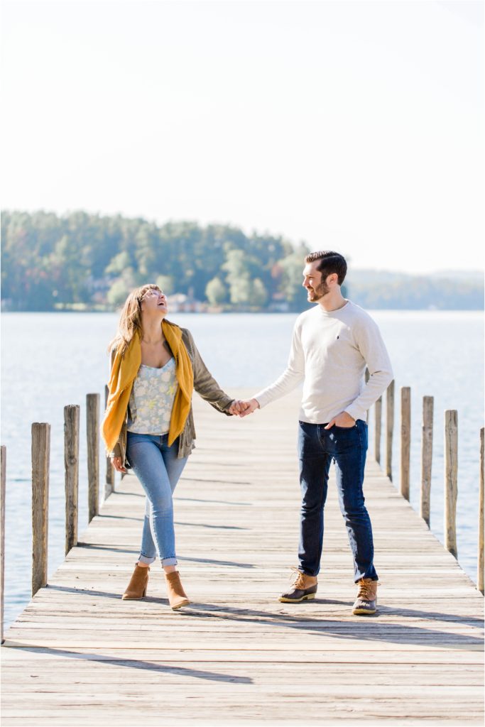 man and woman walking on docks fall engagement photos