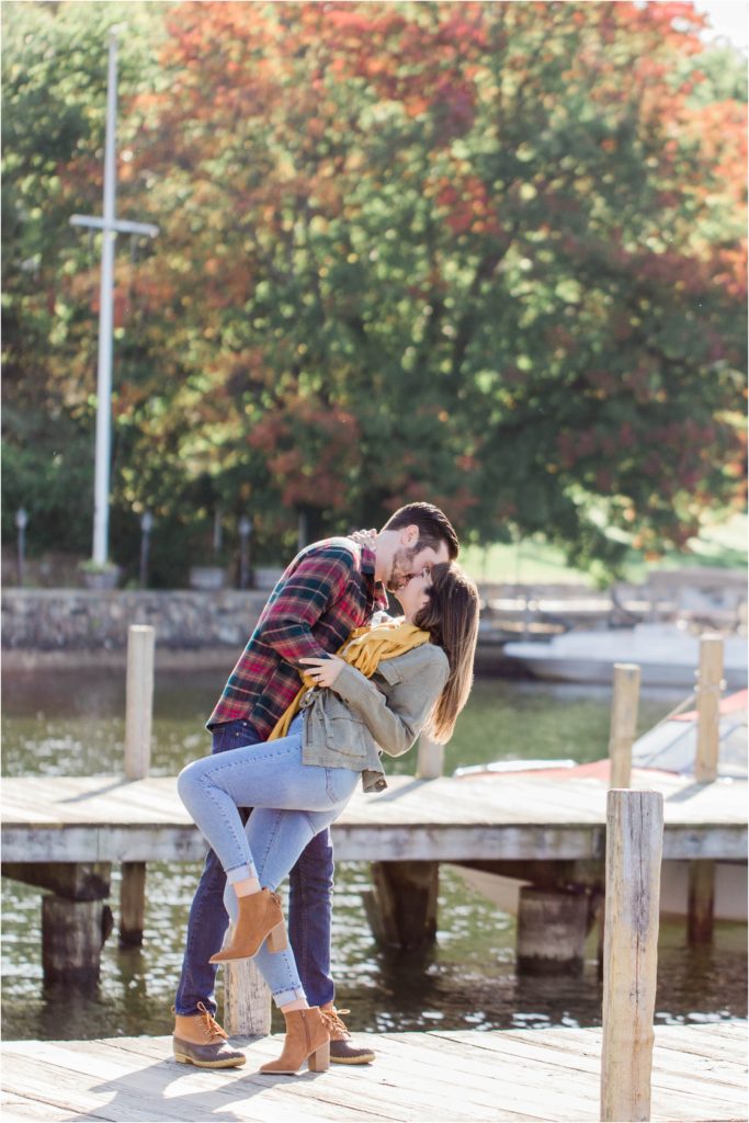 man dipping woman on docks fall engagement photos