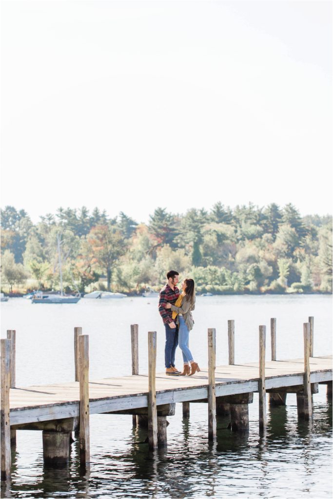 couple standing on docks fall engagement photos