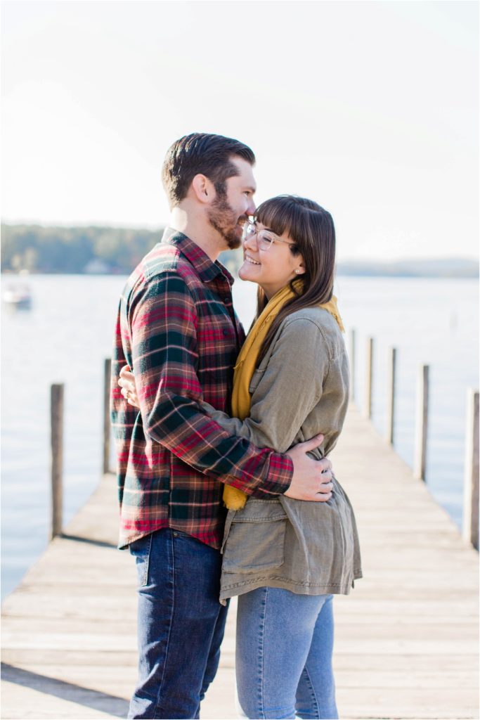 couple laughing on dock engagement photos