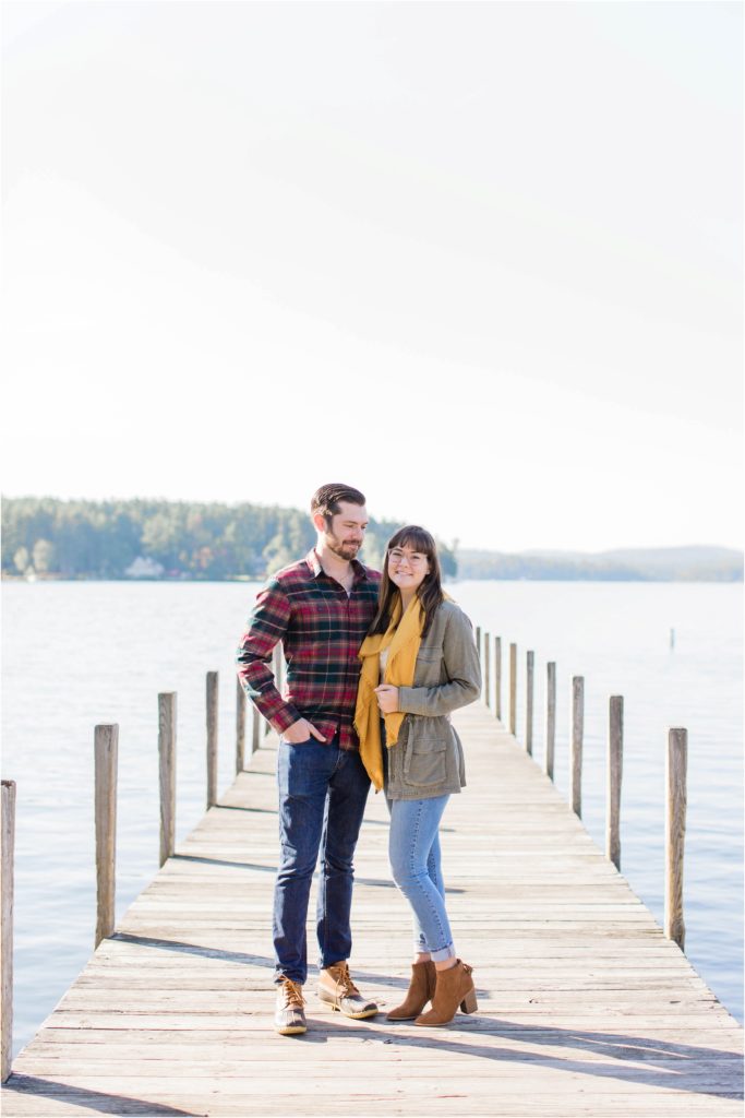 couple standing together on dock in fall