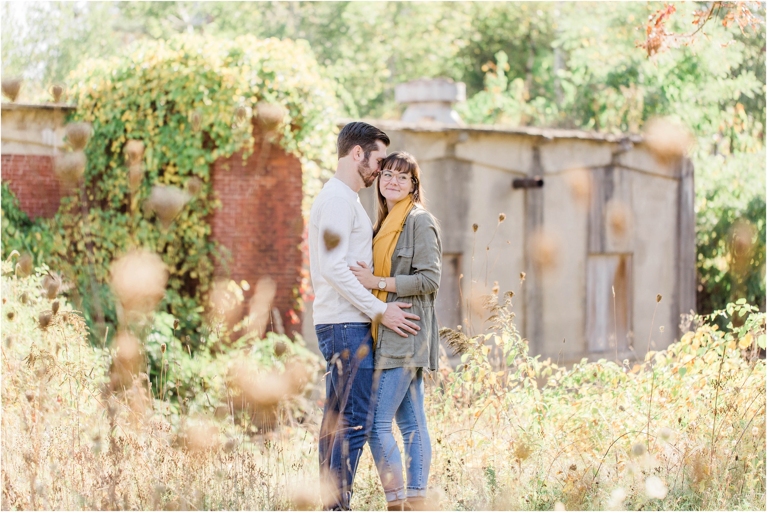 man and woman standing in front of abandoned mill