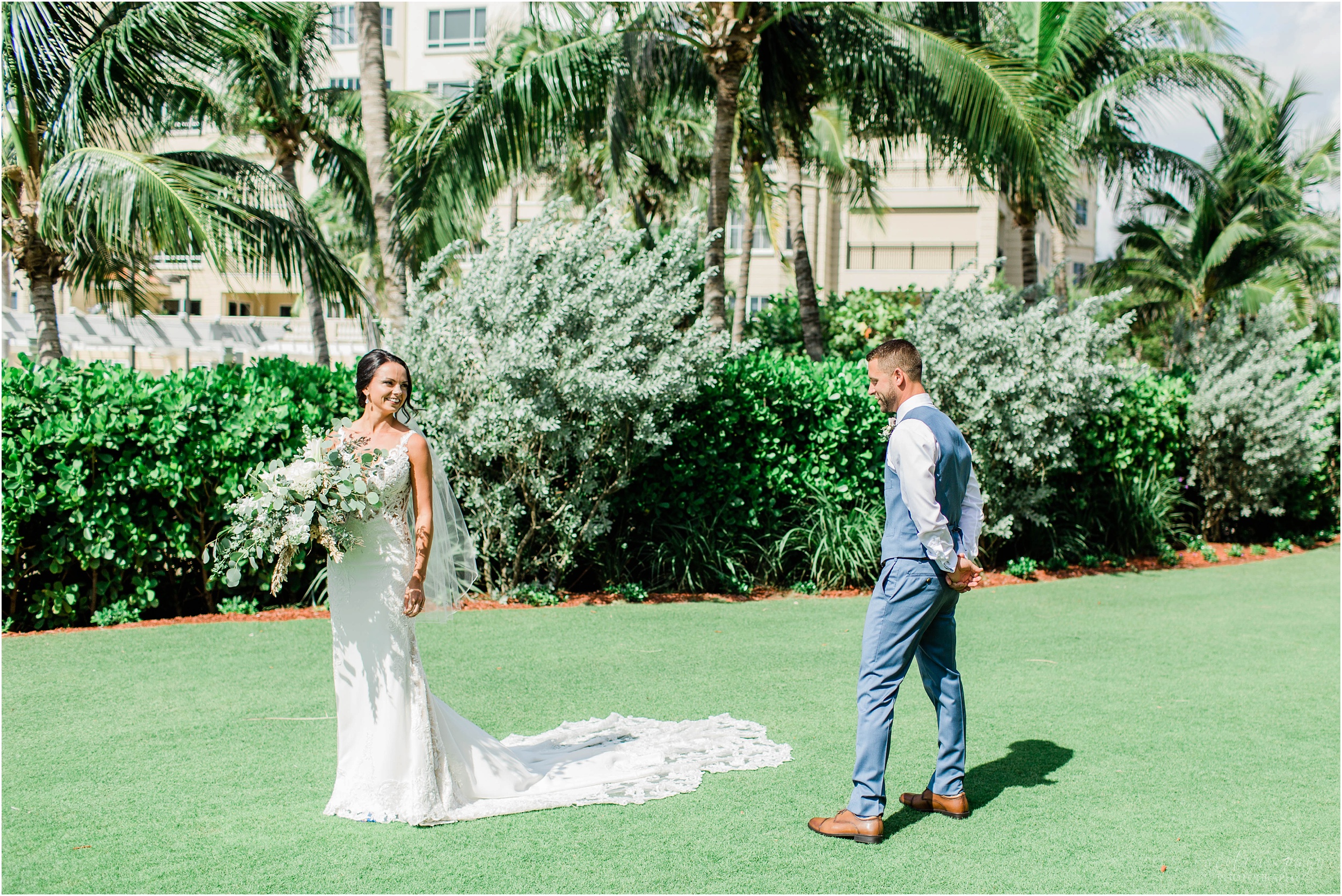 groom walking around bride looking at her dress