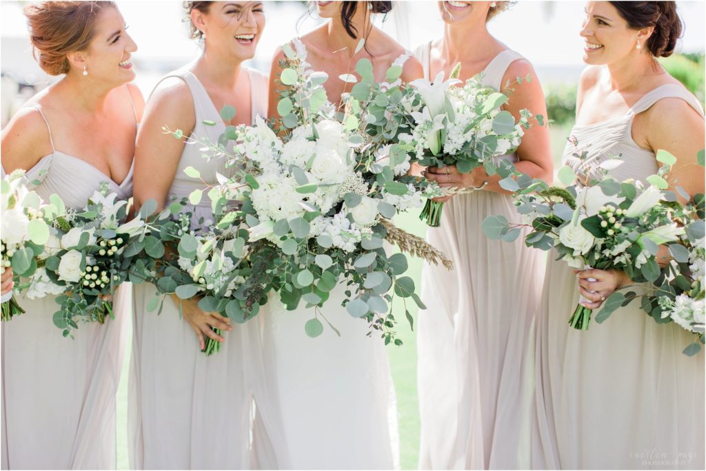 bridesmaids in light green dresses with textured bouquets