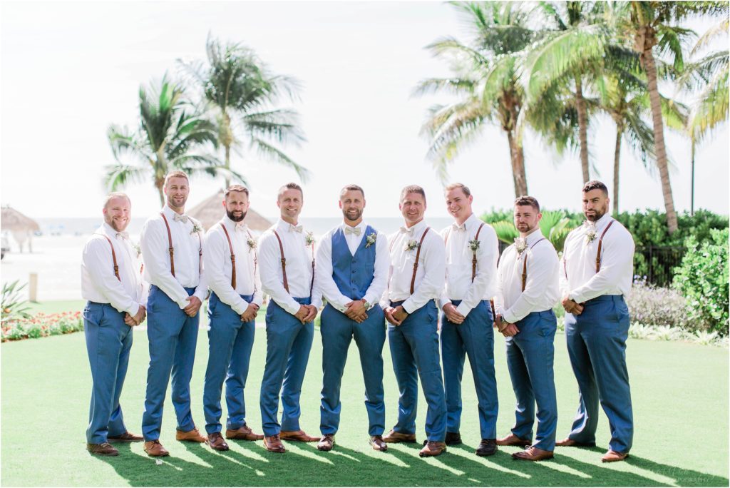 groomsmen in blue pants with leather suspenders