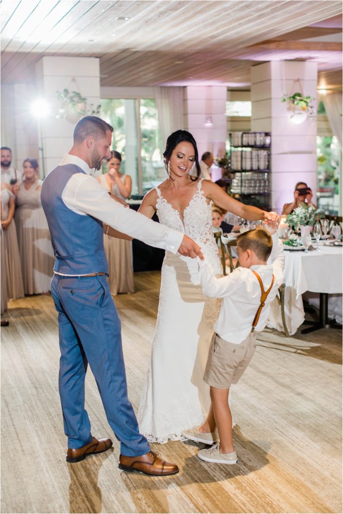 bride and groom first dance with son