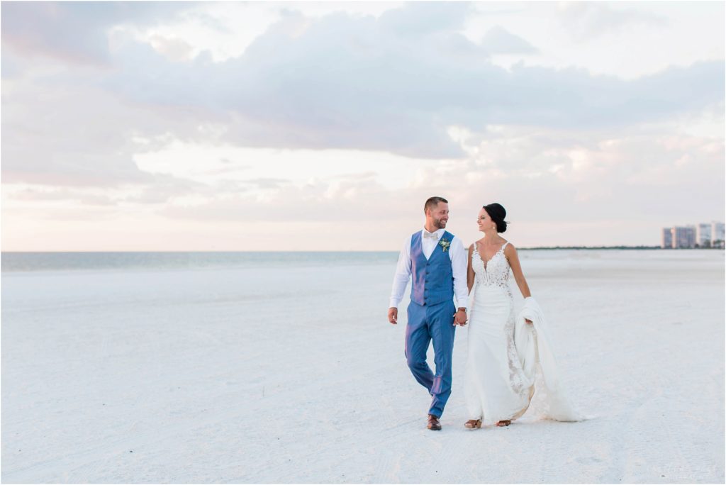 bride and groom walking on beach at sunset on marco island
