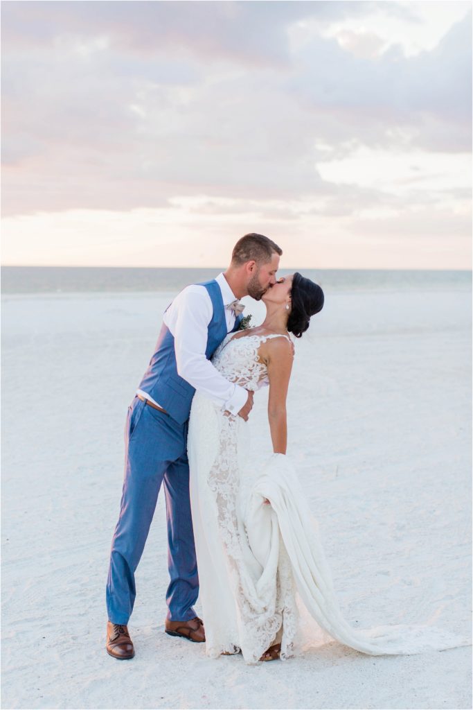 bride and groom standing on beach at sunset on marco island