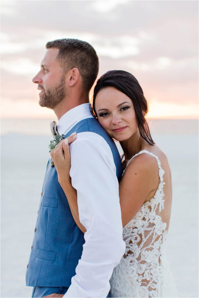 bride and groom standing on beach at sunset on marco island