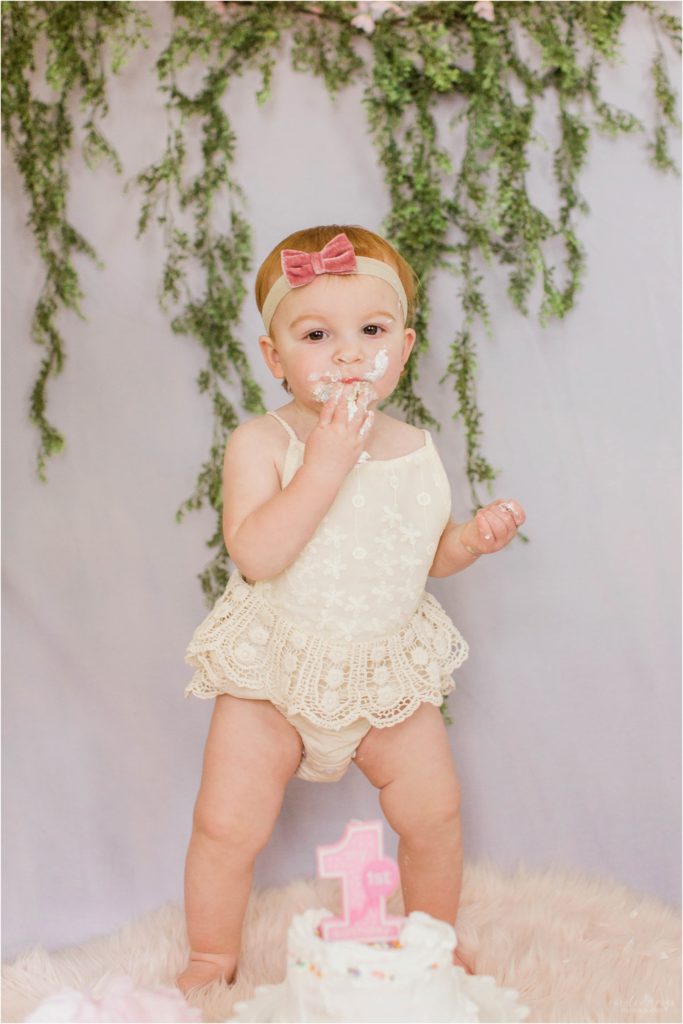 toddler girl with smash cake