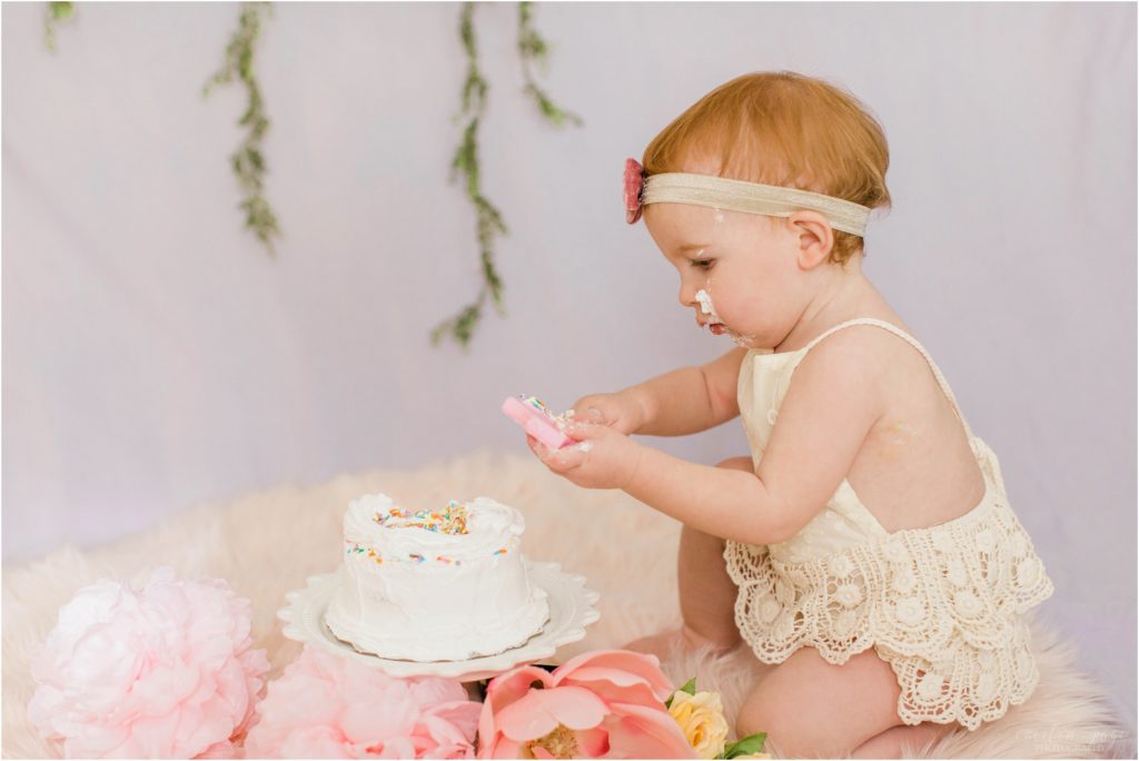 toddler girl with smash cake