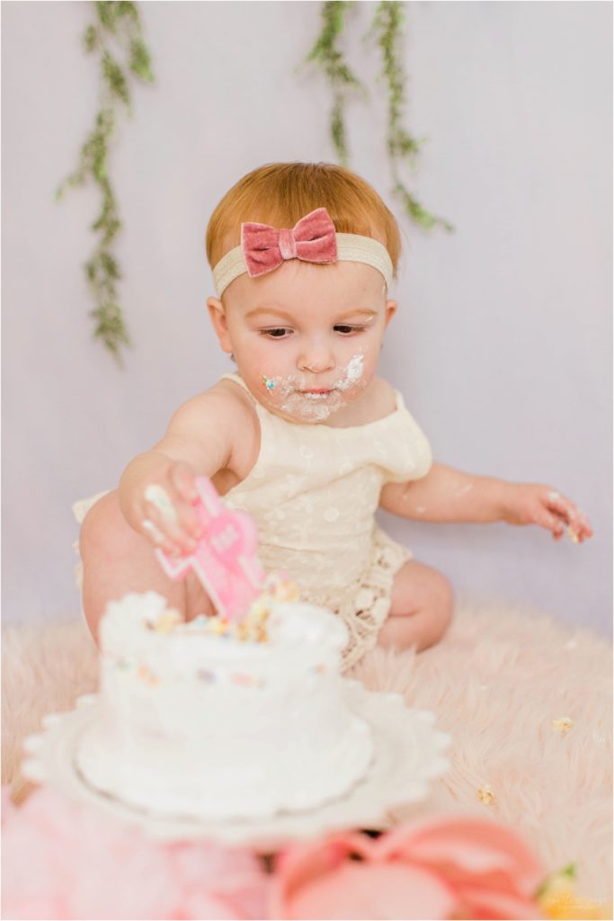 toddler girl with smash cake