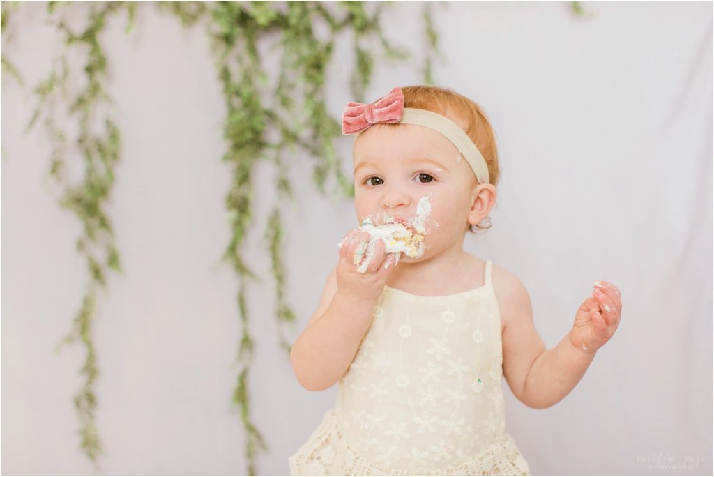 toddler girl with smash cake