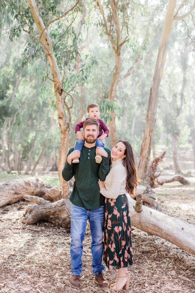 Man and woman standing together with little boy on man's shoulders