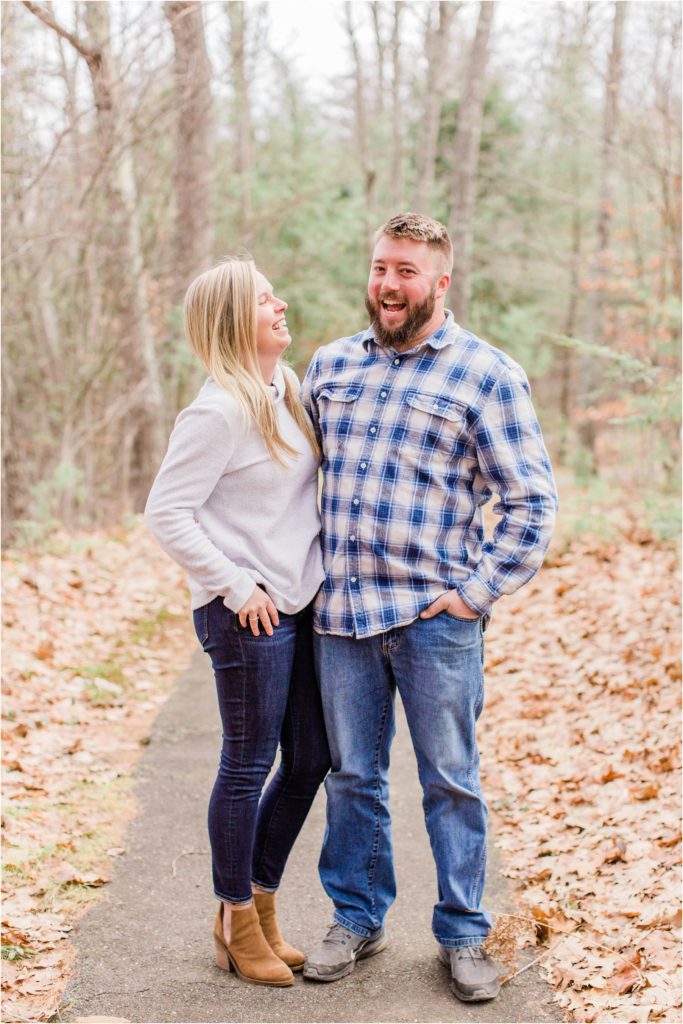 Couple standing in trail covered in leaves
