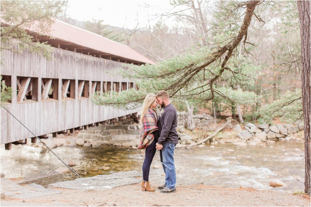 Man and woman standing in front of Albany covered bridge