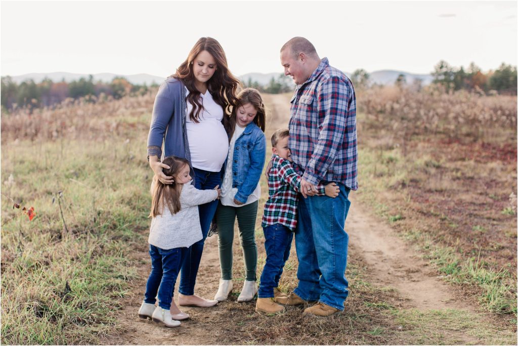 Family snuggling together in field