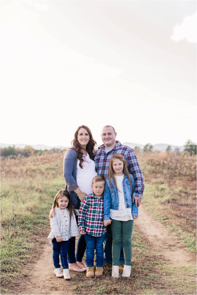 Family of 5 standing in field