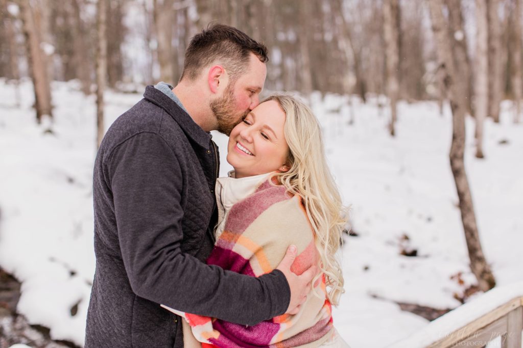 Man kissing woman on the cheek in the snow