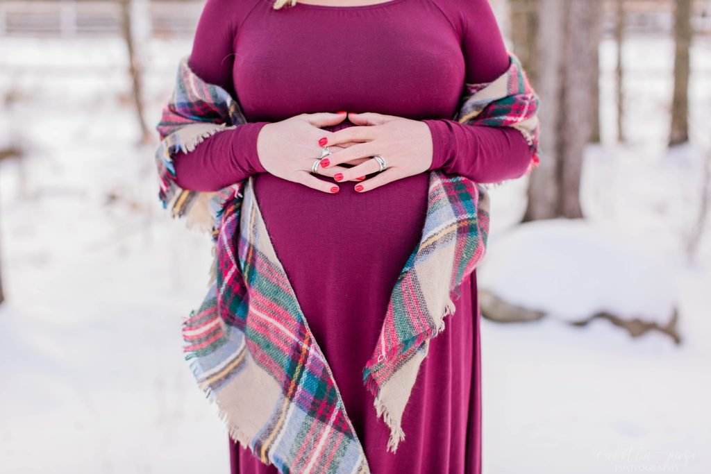 Pregnant belly in red dress with checkered scarf