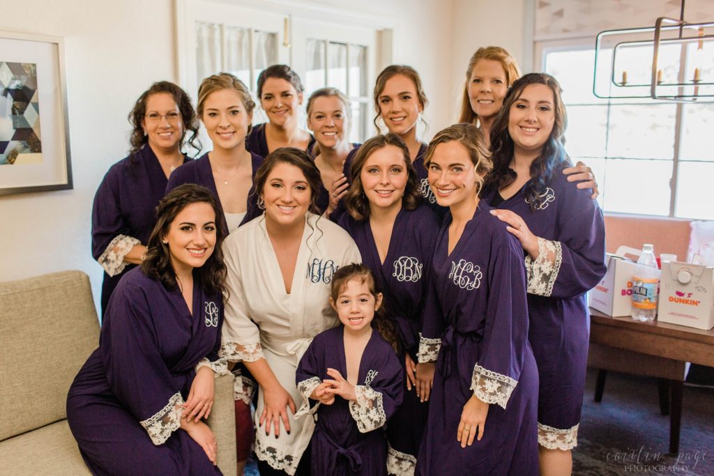 Bridesmaids standing together in matching robes
