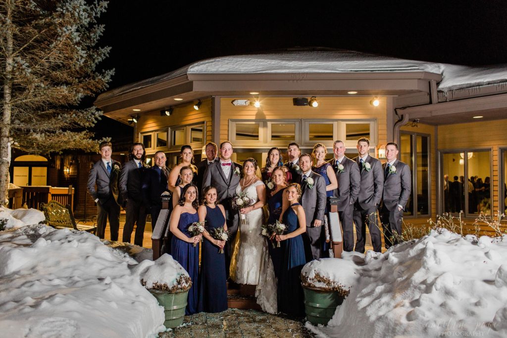 Bridal party on stairs outside in the snow