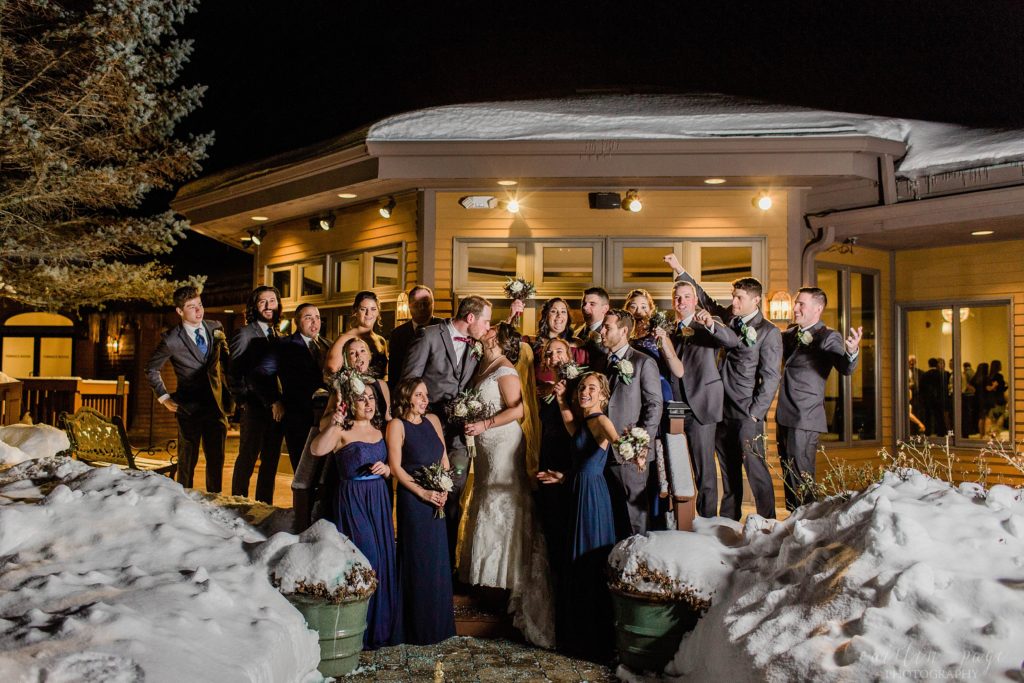 Bridal party on stairs outside in the snow