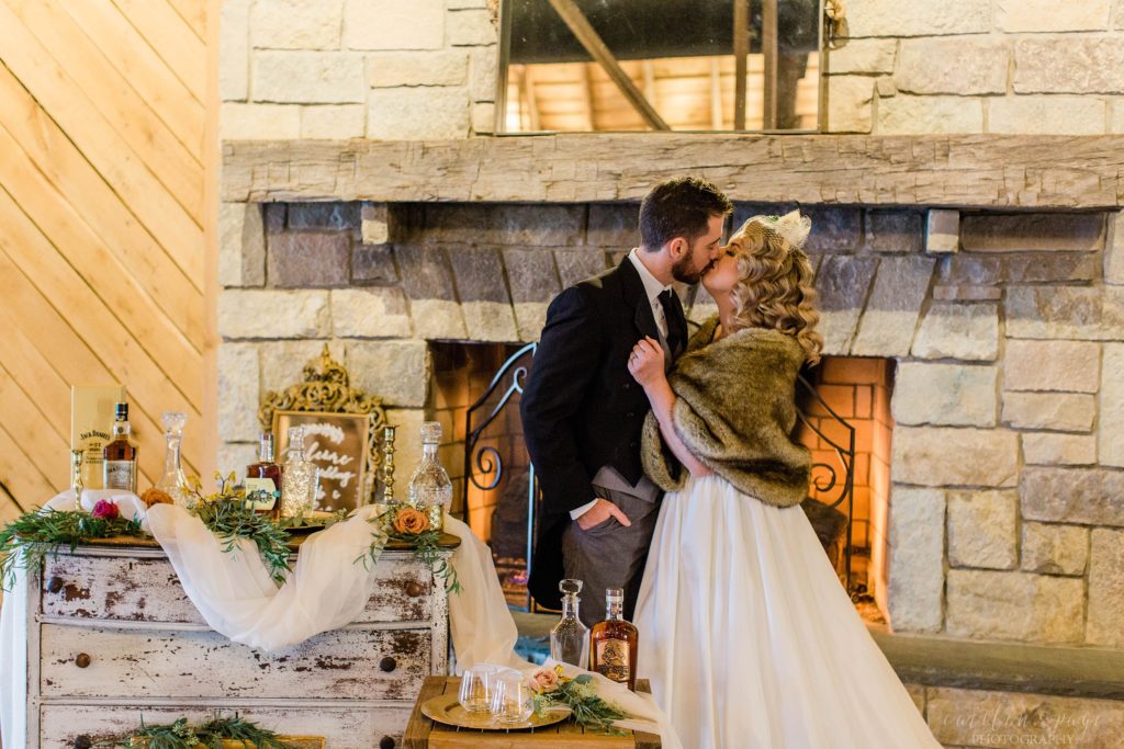 Bride and groom standing in front of fireplace at Mount Ida Farm in Charlottesville Virginia