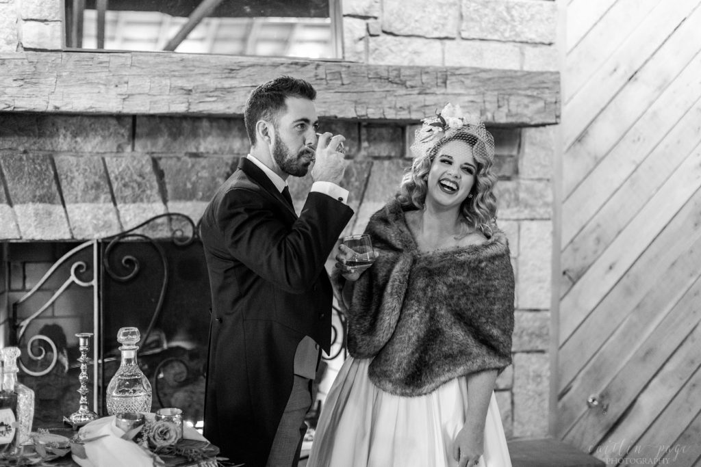 Black and white portrait of bride and groom standing in front of fireplace at Mount Ida Farm in Charlottesville Virginia