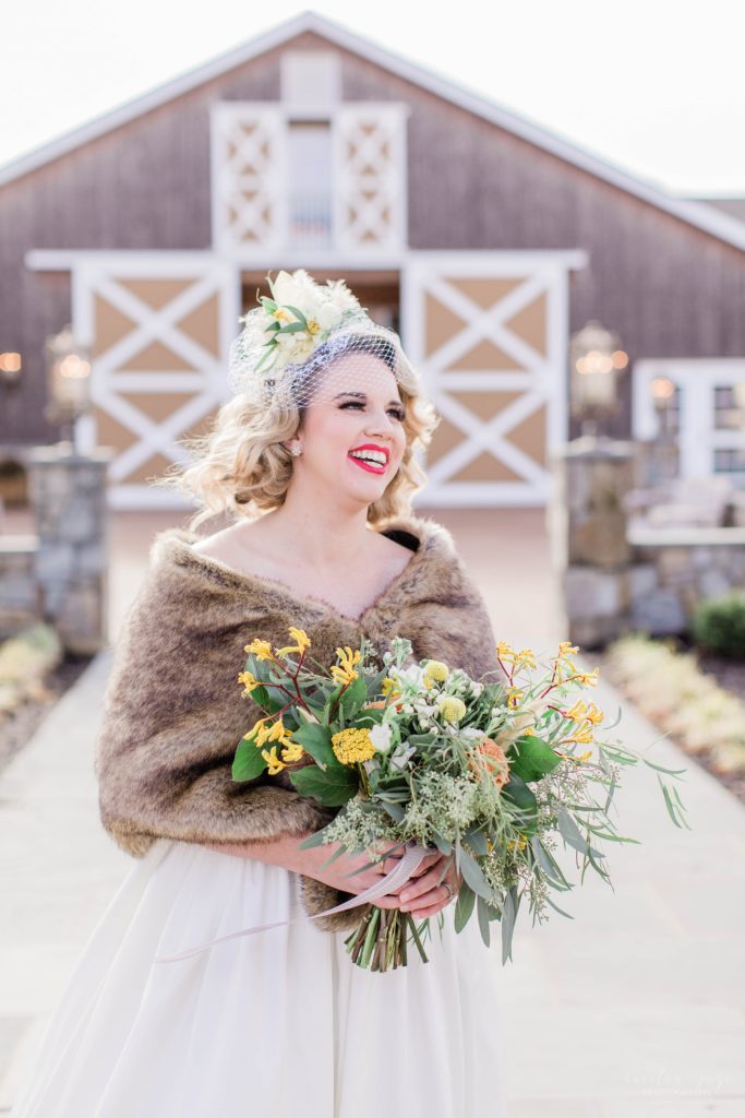 Bride laughing in front of barn at Mount Ida Farm in Charlottesville Virginia