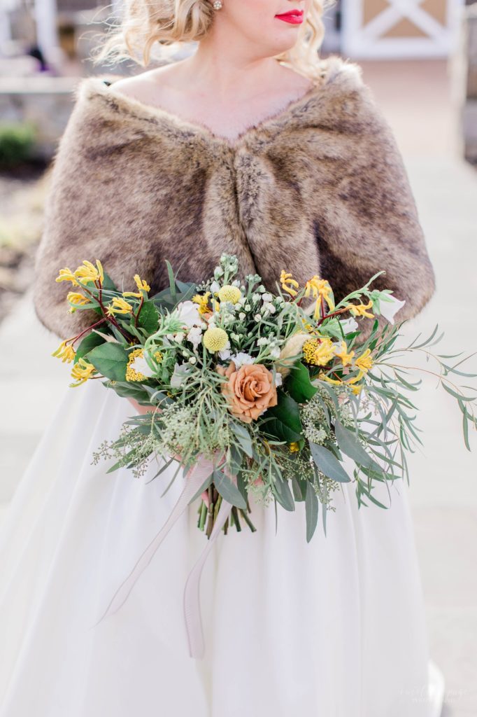 Bridal bouquet with oranges and yellows at Mount Ida Farm in Charlottesville Virginia