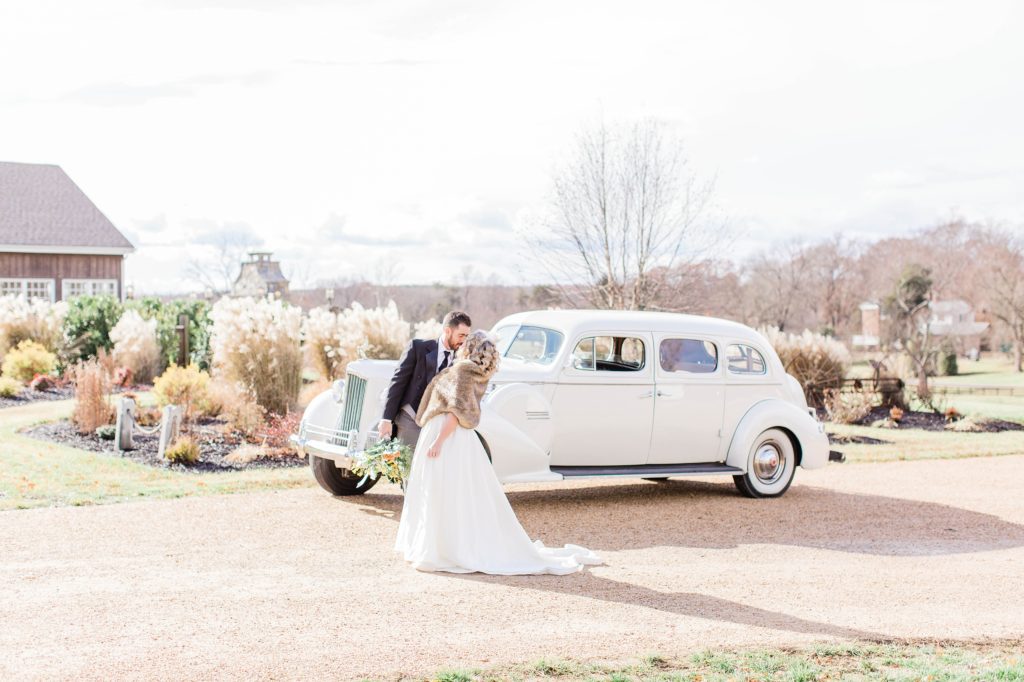 Bride and groom in front of vintage car at Mount Ida Farm in Charlottesville Virginia