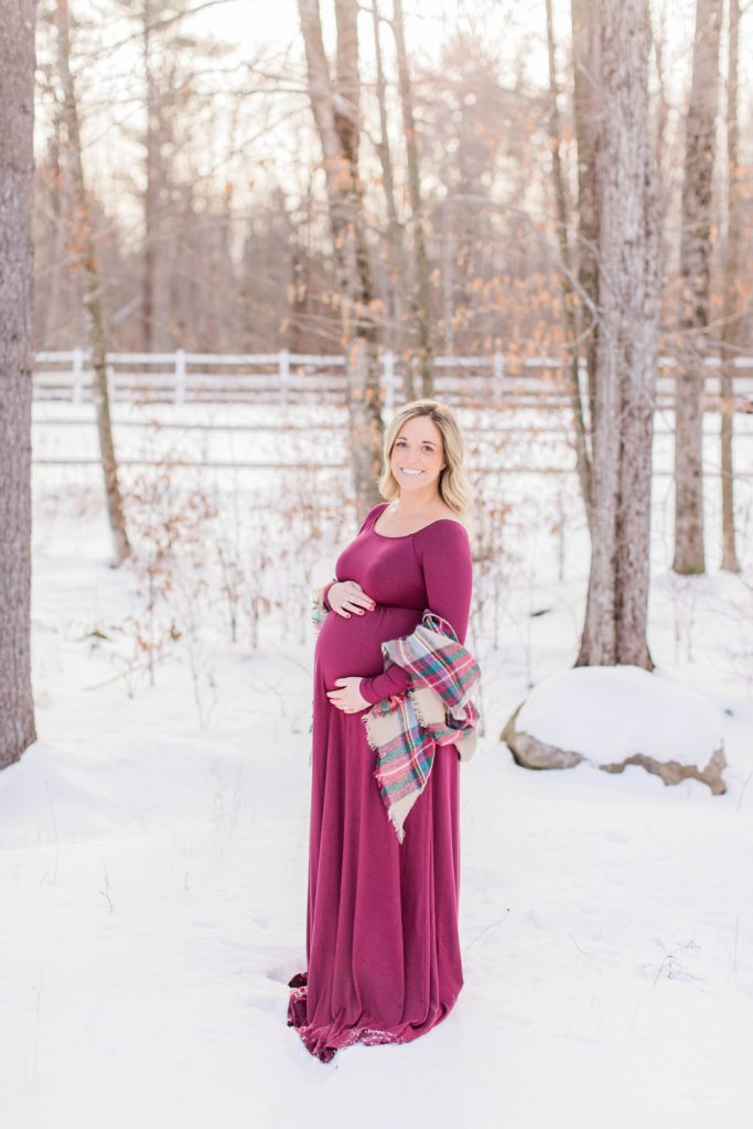Pregnant woman standing in a small field in Moultonbourough New Hampshire