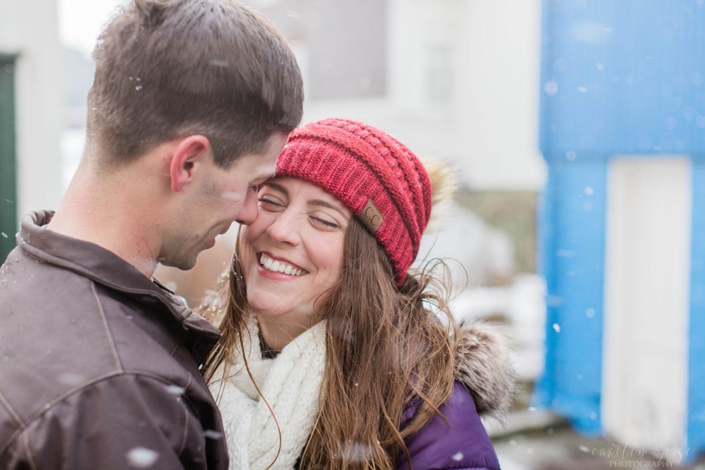 Man and woman nuzzling together in the snow