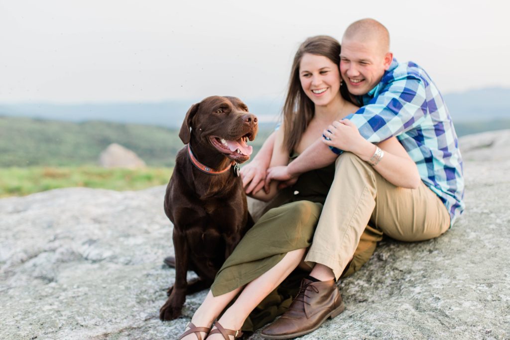 Man, woman and chocolate lab sitting togeher