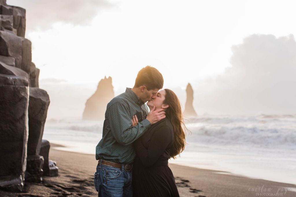 Man and woman kissing at sunrise on Reynisfjara Beach in Iceland