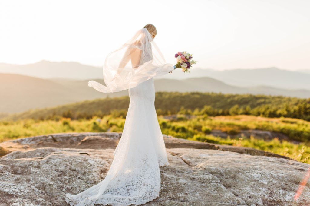 Woman walking away on a mountaintop in a wedding gown
