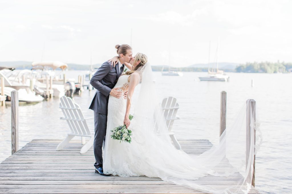 Bride and groom kissing on a dock