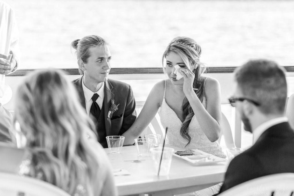 Bride wiping tears away at wedding reception