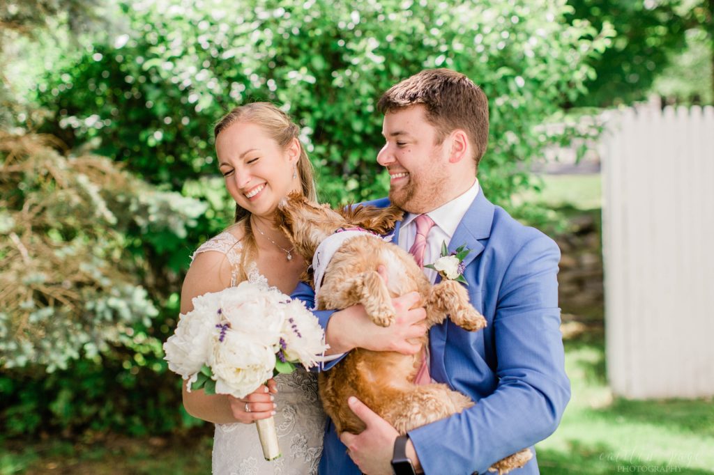 Bride getting kisses from puppy