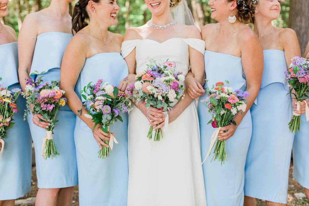 Bride & bridesmaids holding wildflower bouquets