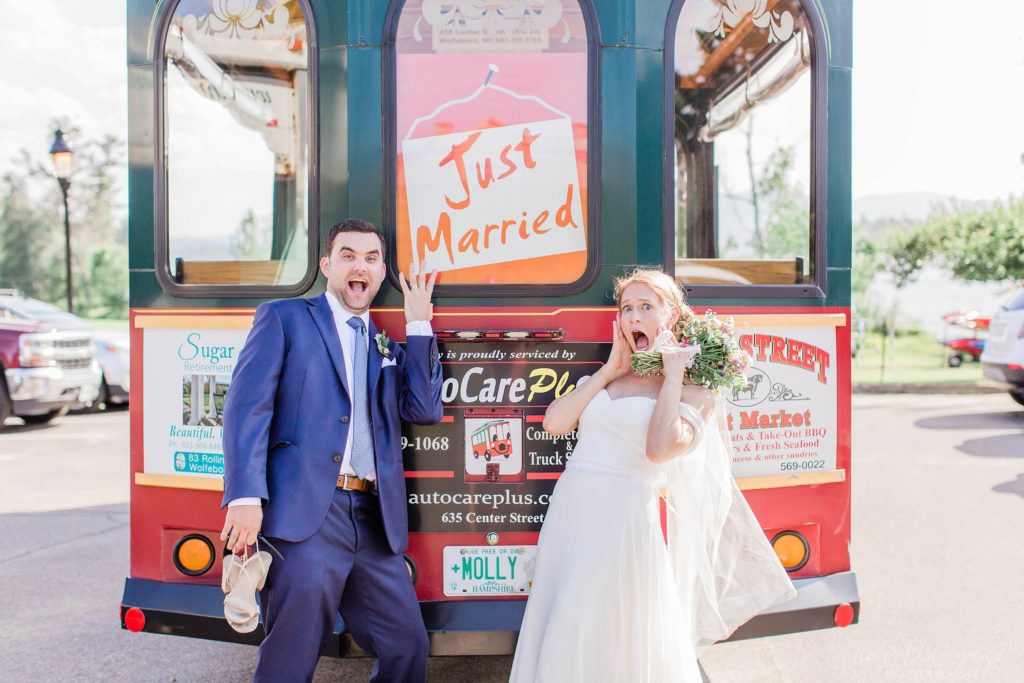 Bride and groom standing in front of trolley